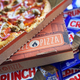 Open box of Blaze Pizza on top of a pile of Crunch bars